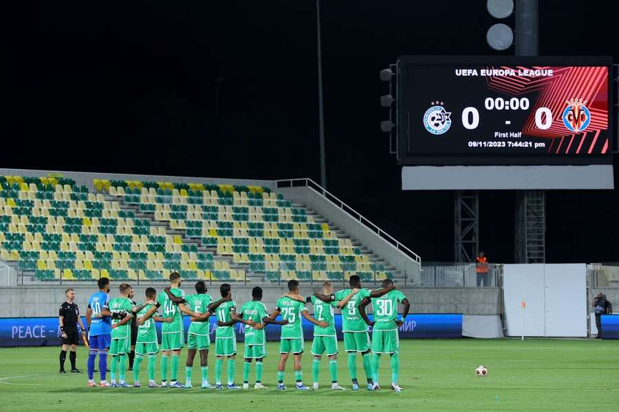 Maccabi Haifa's players stand before kick-off