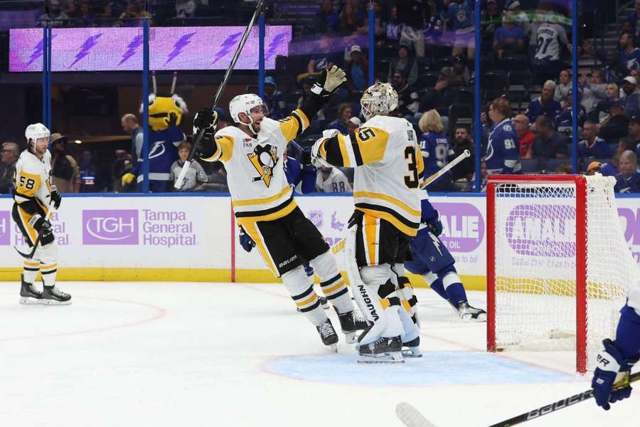 Tristan Jarry and defenseman Marcus Pettersson (28) celebrate after they beat the Tampa Bay Lightning