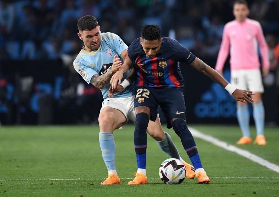 Celta Vigo defender Javi Galan (L) vies with Barcelona forward Raphinha