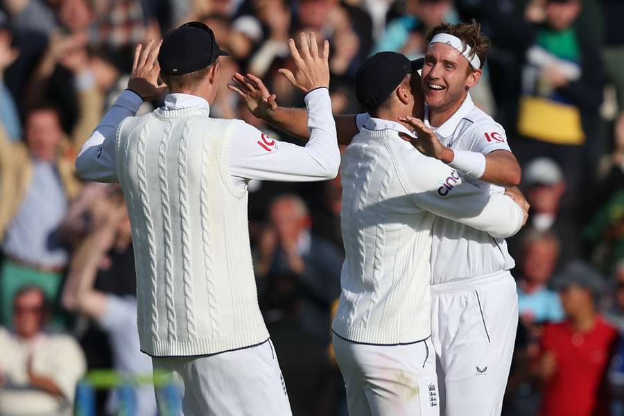 England's Stuart Broad (R) celebrates after England's victory on day five of the fifth Ashes cricket Test