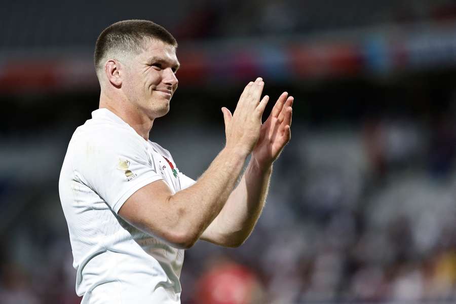 England's fly-half and captain Owen Farrell applauds the supporters