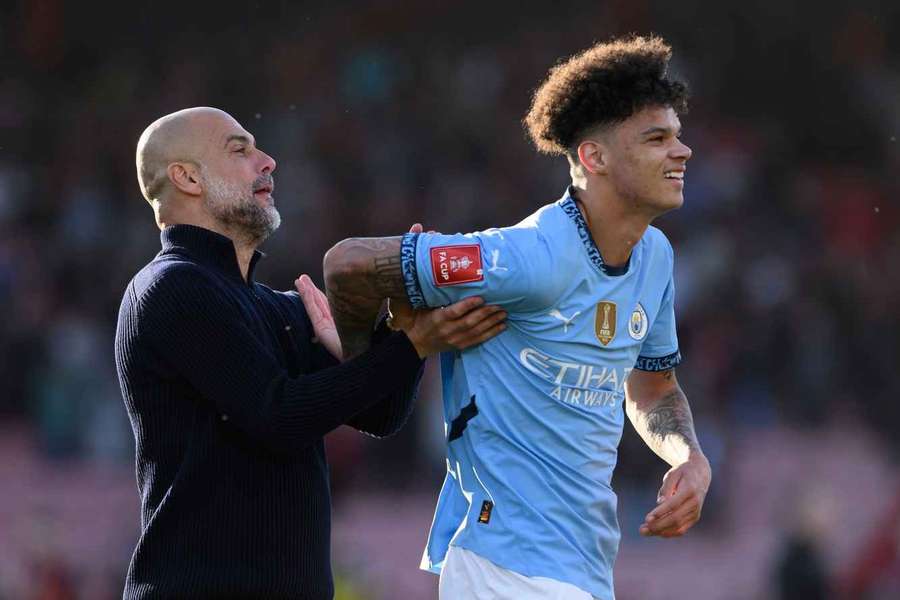 Manchester City manager Pep Guardiola and Nico O'Reilly at the final whistle