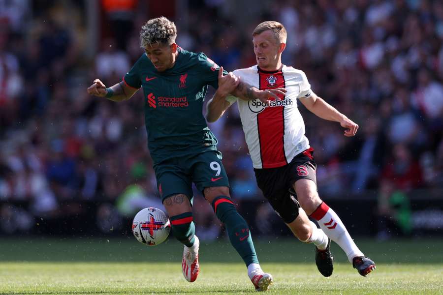 Liverpool's Brazilian striker Roberto Firmino (L) vies with Southampton's English midfielder James Ward-Prowse