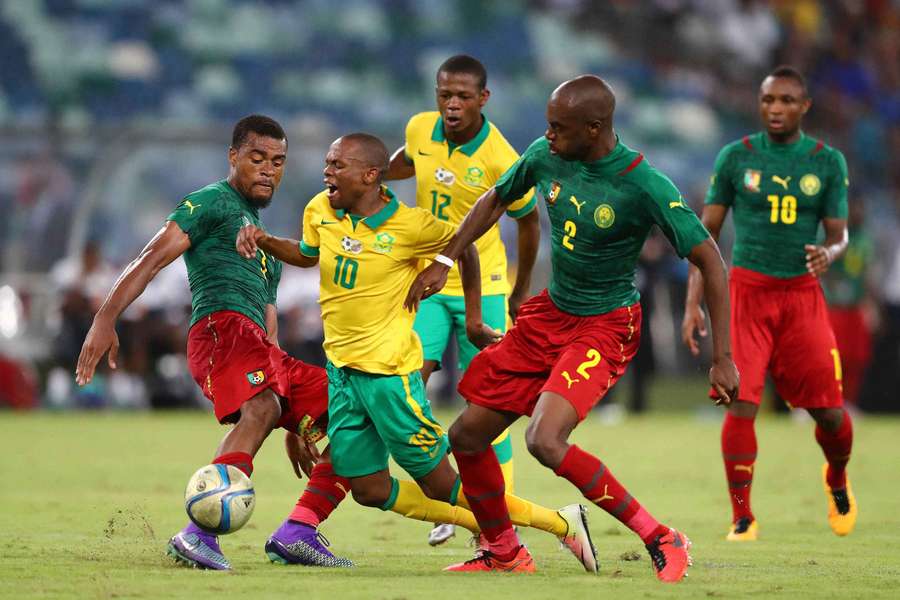 South Africa's forward Thulani Serero is tackled by Cameroon's Allan Nyom (right) and Jean-Patrick Abouna in 2016. 