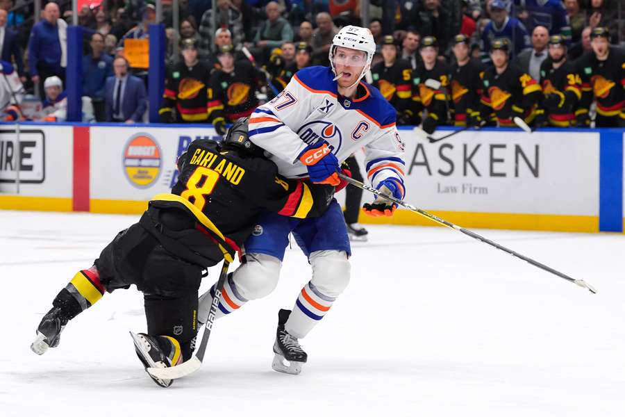 Connor McDavid and Conor Garland getting tangled up during the Oilers-Canucks game on January 18, 2025.