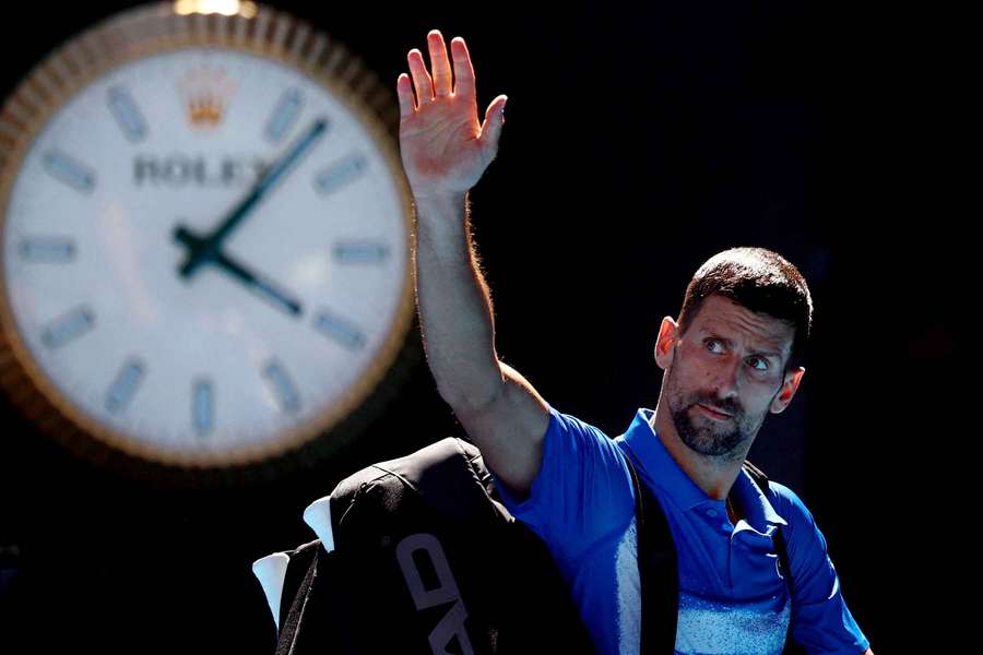Novak Djokovic waves to the crowd as he leaves the court after retiring from his semi-final against Alexander Zverev