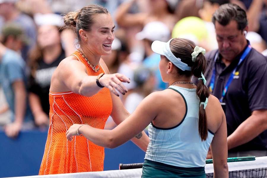 Sabalenka (left) embraces Rakhimova at the net