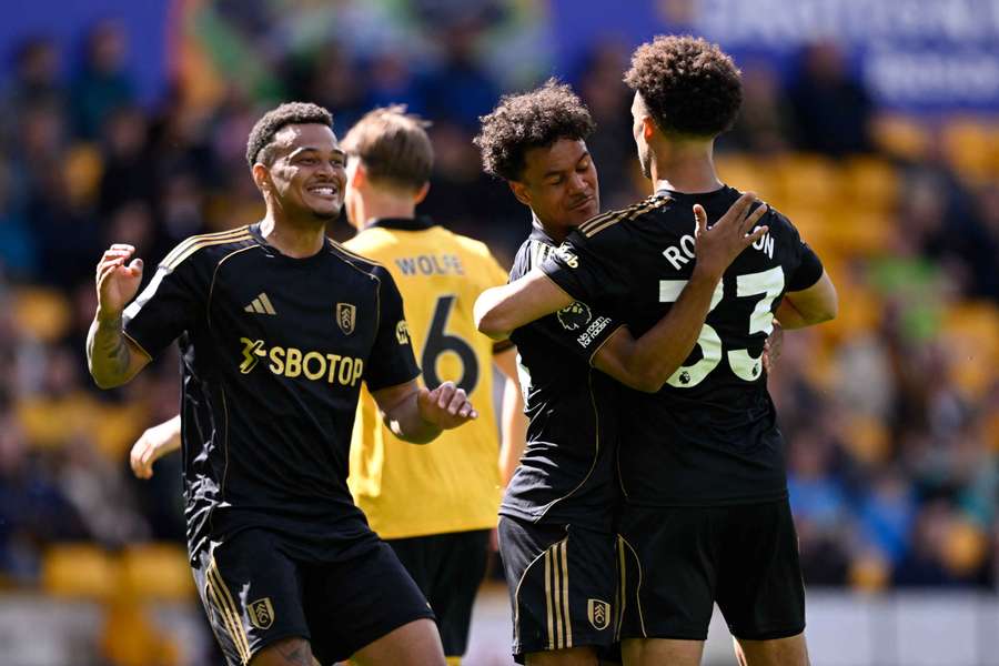 Antonee Robinson celebrates scoring Fulham's equalising goal with Oscar Bobb and Rodrigo Muniz