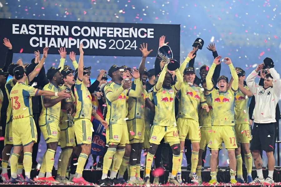New York Red Bulls players celebrate with the Eastern Conference trophy after defeating Orlando City