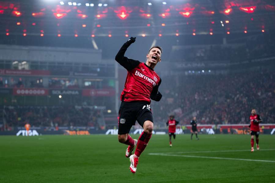 Bayer Leverkusen's Alex Grimaldo celebrates after scoring against Mainz