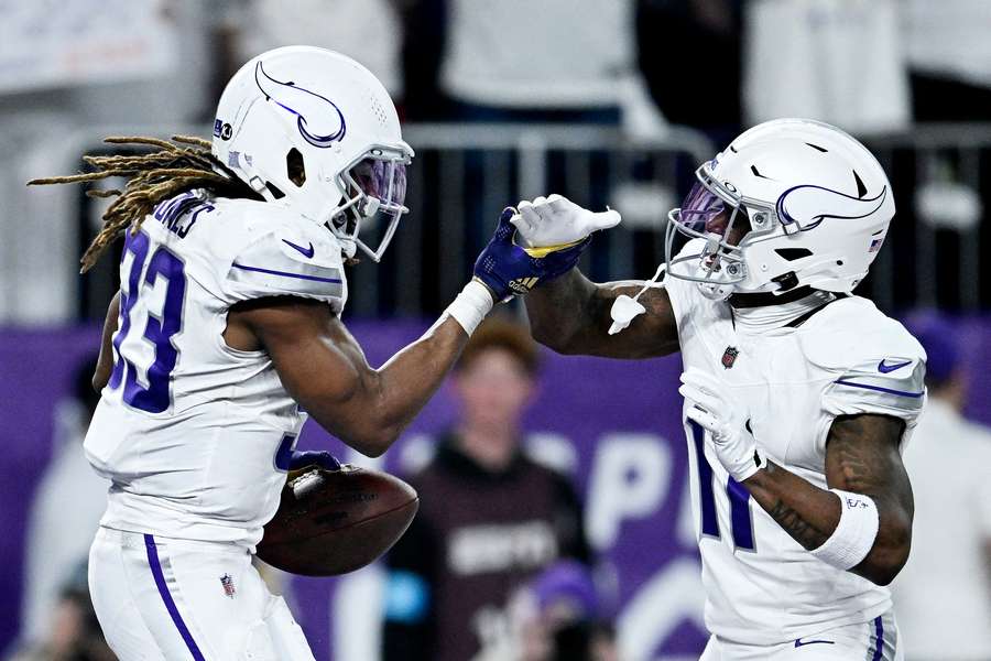 Aaron Jones celebrates with Trent Sherfield Sr. of the Minnesota Vikings after a scoring touchdown against the Chicago Bears
