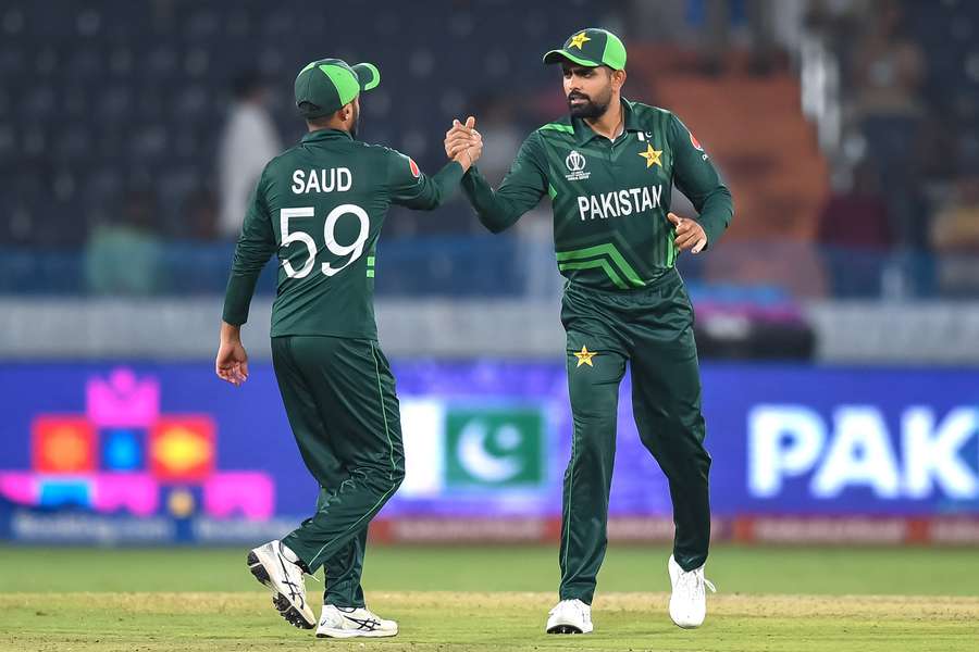 Pakistan captain Babar Azam (R) celebrates with teammate Saud Shakeel