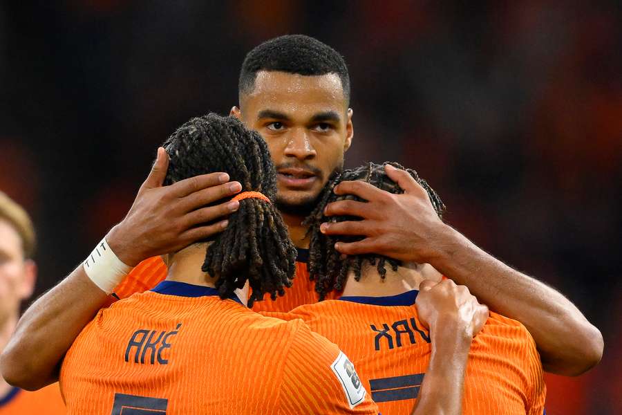 Cody Gakpo celebrates scoring against Finland with Nathan Ake (L) and Xavi Simons
