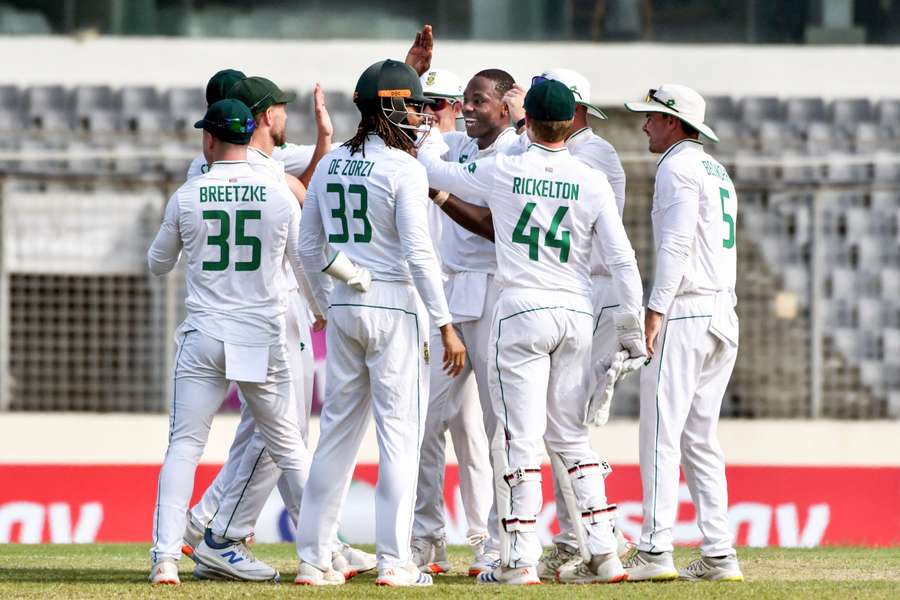 Rabada (centre) celebrates with teammates after taking a wicket