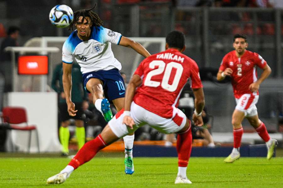 England defender Trent Alexander-Arnold (L) kicks the ball