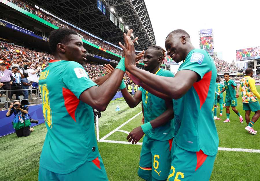 Senegal's Ismaila Sarr celebrates scoring their second goal with Pathe Ciss and Pape Gueye Senegal's Ismaila Sarr celebrates scoring their second goal with Pathe Ciss and Pape Gueye