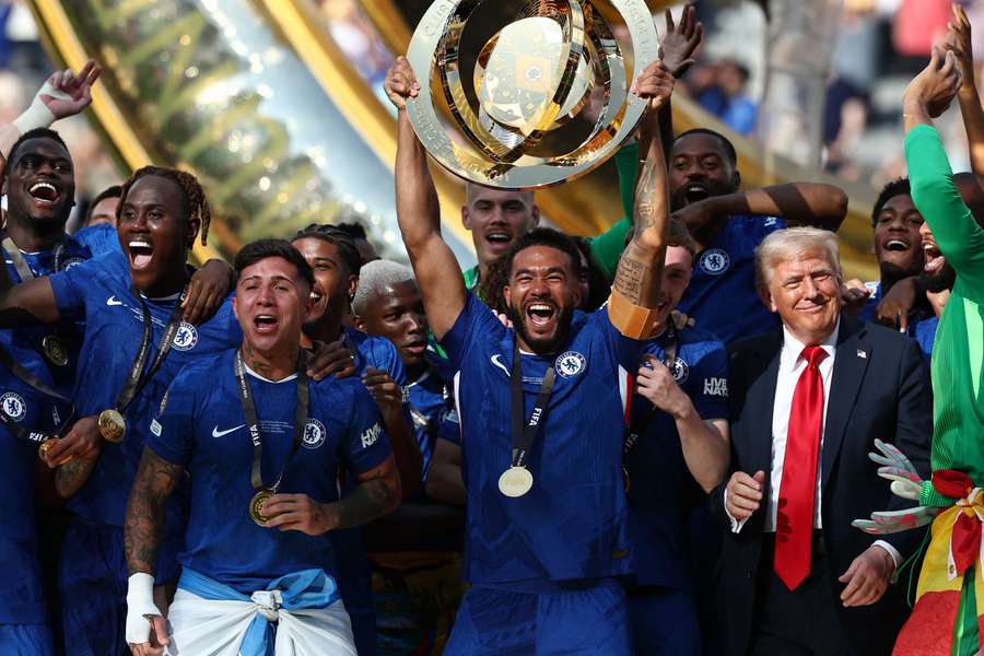 Reece James lifts the Club World Cup trophy next to US President Donald Trump