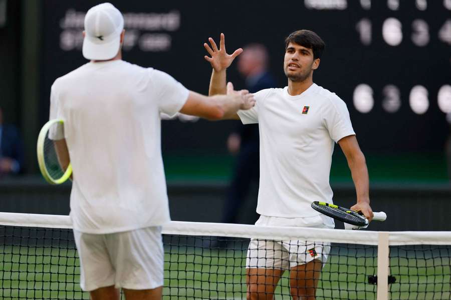 Carlos Alcaraz and Jan-Lennard Struff embrace at the net