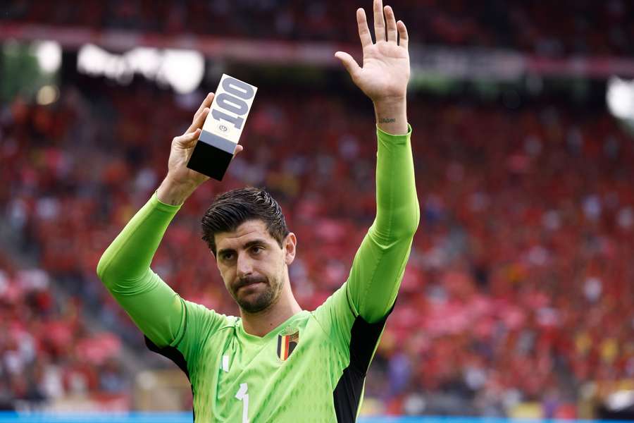 Thibaut Courtois holds up a trophy as he celebrates his 100th match with the Belgian national team prior to the match between Belgium and Austria