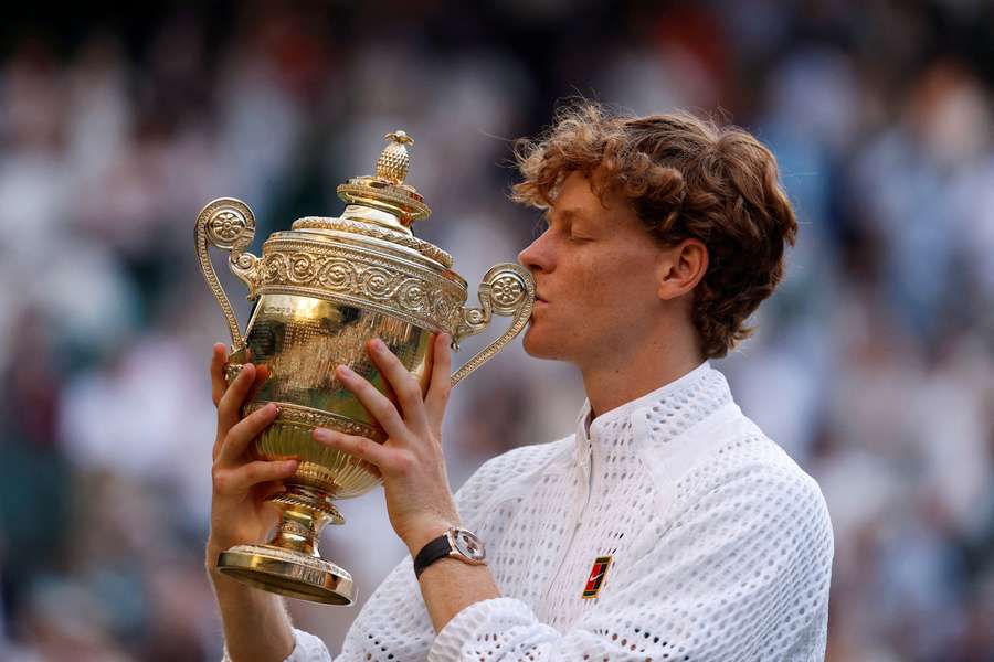 Jannik Sinner celebrates with the trophy after winning the Wimbledon final