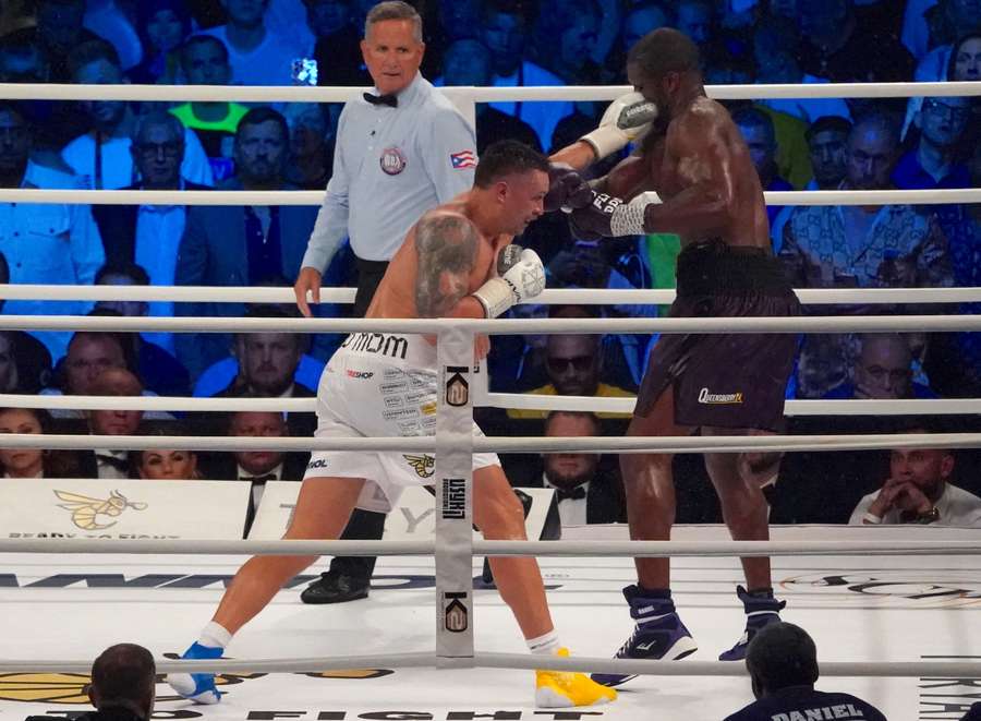 Ukraine’s reigning world heavyweight champion Oleksandr Usyk (L) fights challenger Daniel Dubois of Great Britain in 2023