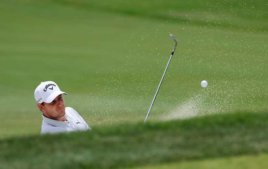 Emiliano Grillo of Argentina blasts from a bunker