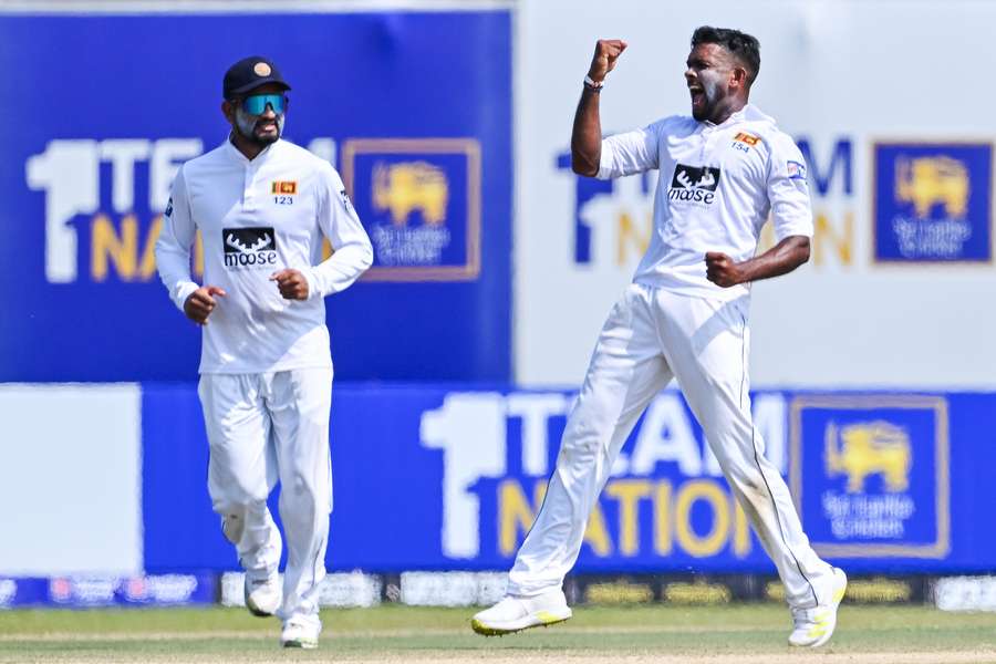 Sri Lanka's Ramesh Mendis (R) celebrates after taking a wicket