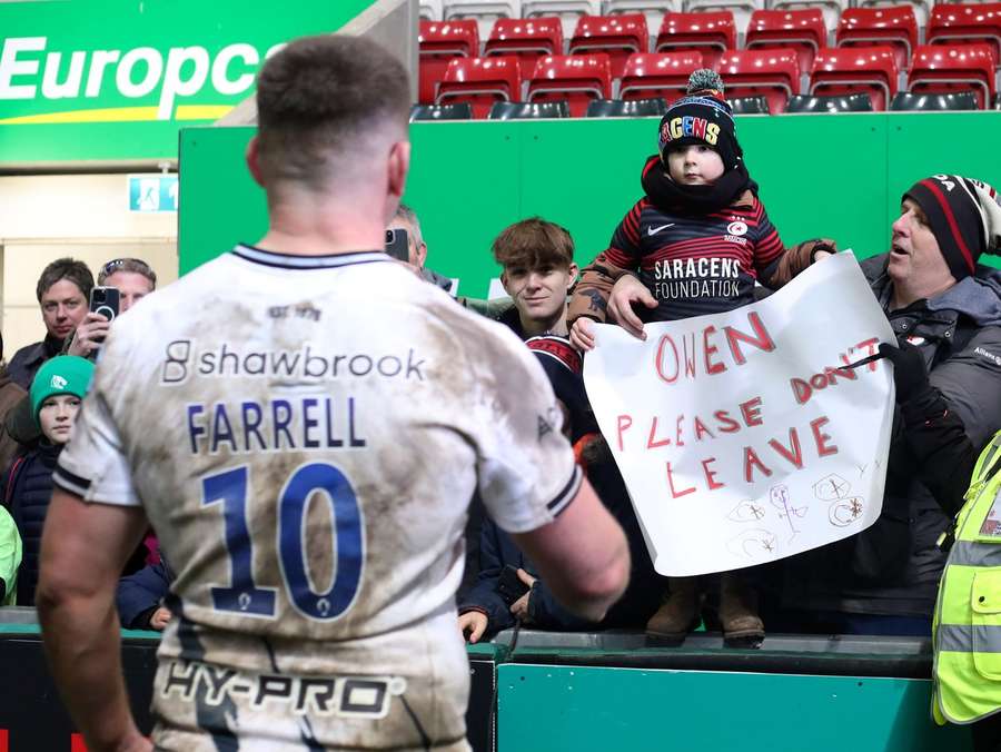 A young fan holds up a message to Farrell