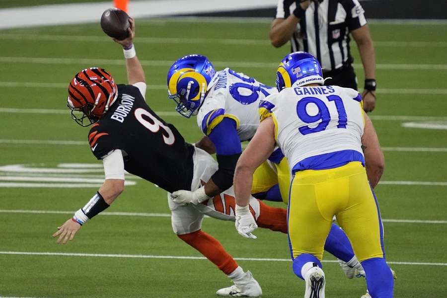 Los Angeles Rams defensive end Aaron Donald (99) tackles Cincinnati Bengals quarterback Joe Burrow (9) at 2022 Super Bowl