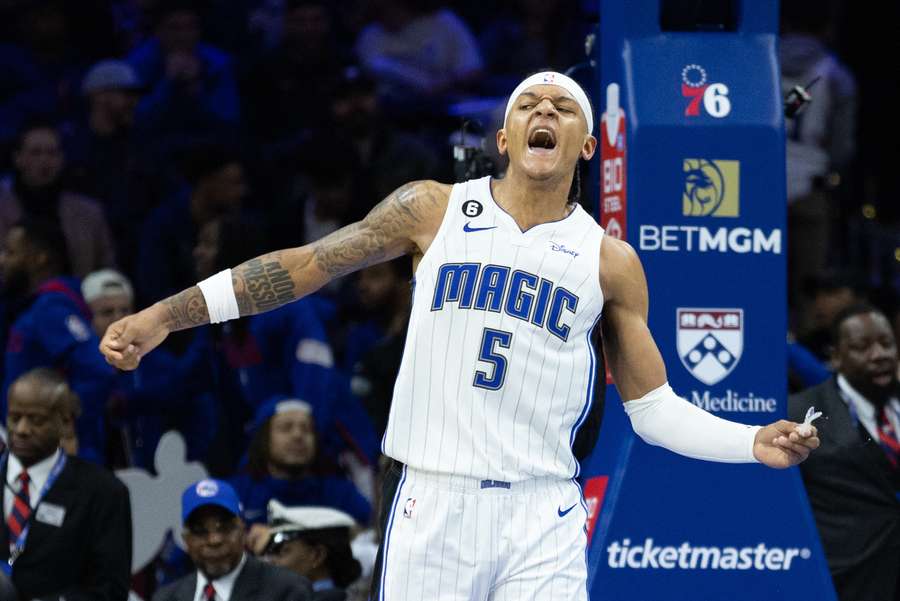 The Magic's Banchero reacts after dunking the ball against the 76ers