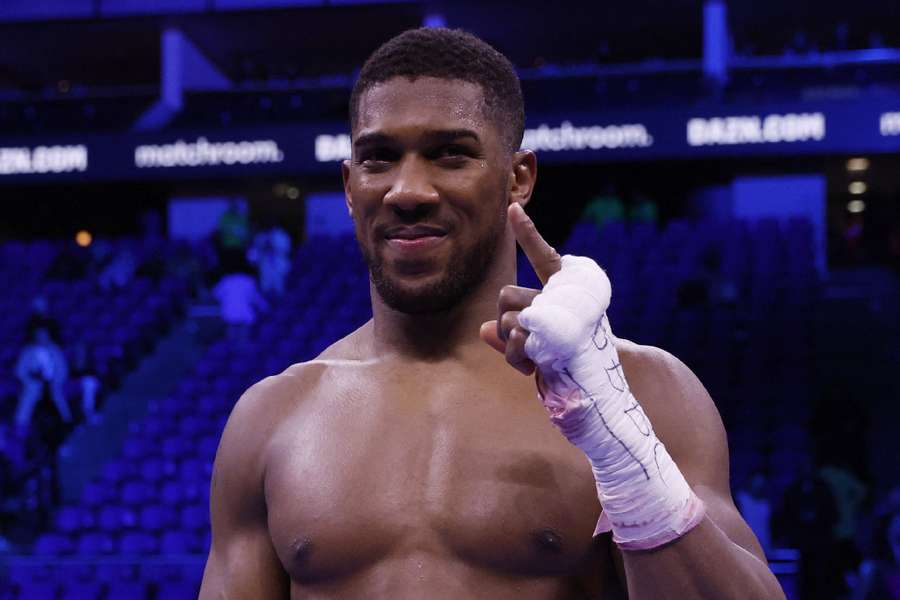 Anthony Joshua poses in the ring after winning his fight against Jermaine Franklin