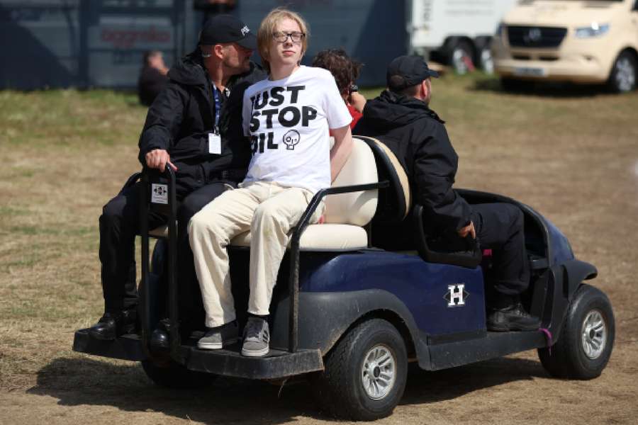 A Just Stop Oil protester is driven from the course by security