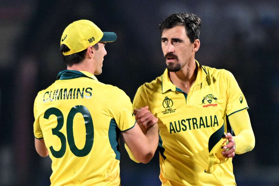 Australia's captain Pat Cummins (L) celebrates with Mitchell Starc after their win