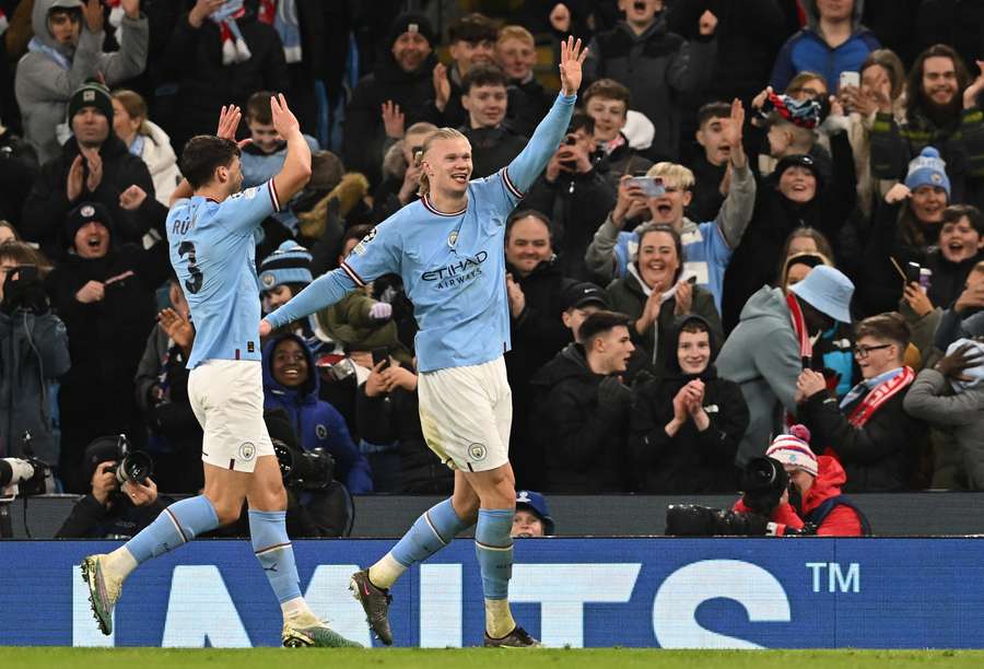 Manchester City's Norwegian striker Erling Haaland (R) celebrates scoring his fifth goal