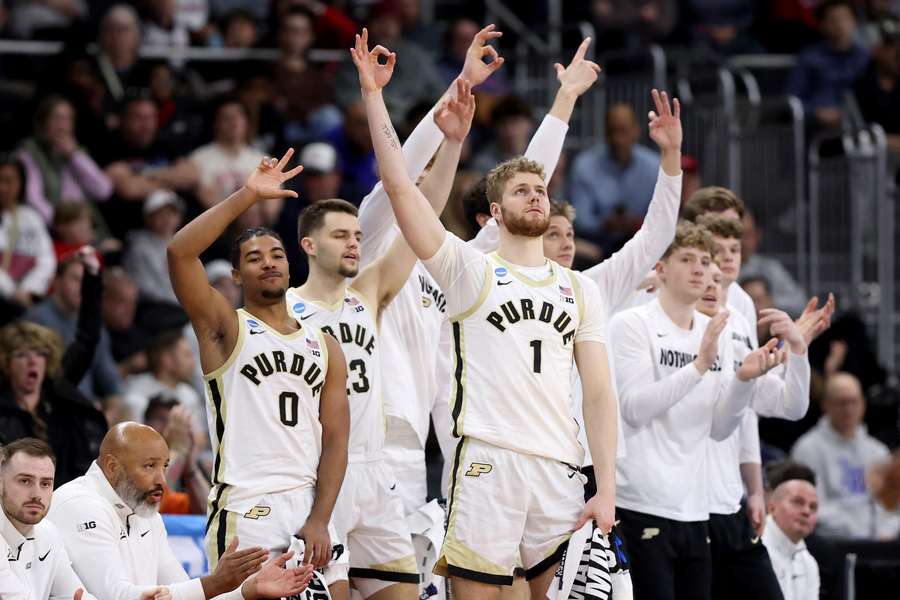 Purdue players celebrate after a teammate drains a three-point shot against Michigan
