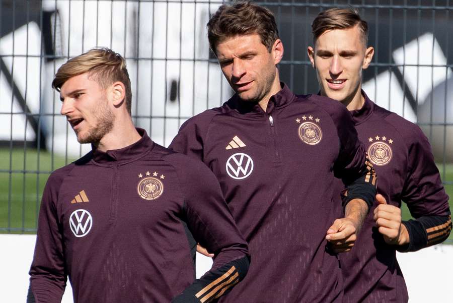 Timo Werner, Thomas Mueller and Nico Schlotterbeck warm up during a training session