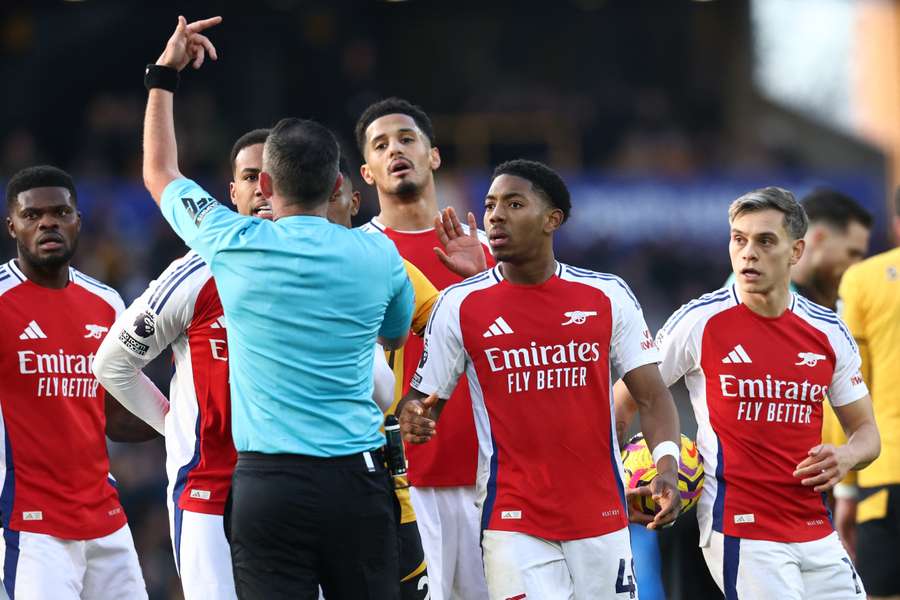 Arsenal's Myles Lewis-Skelly reacts after being sent off by referee Michael Oliver