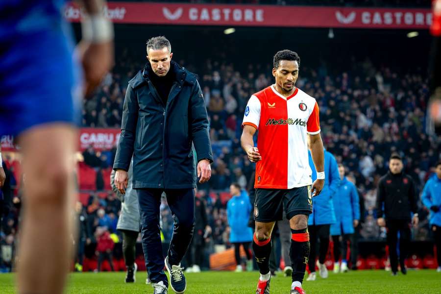 Feyenoord's Quinten Timber (R) walks beside manager Robin van Persie