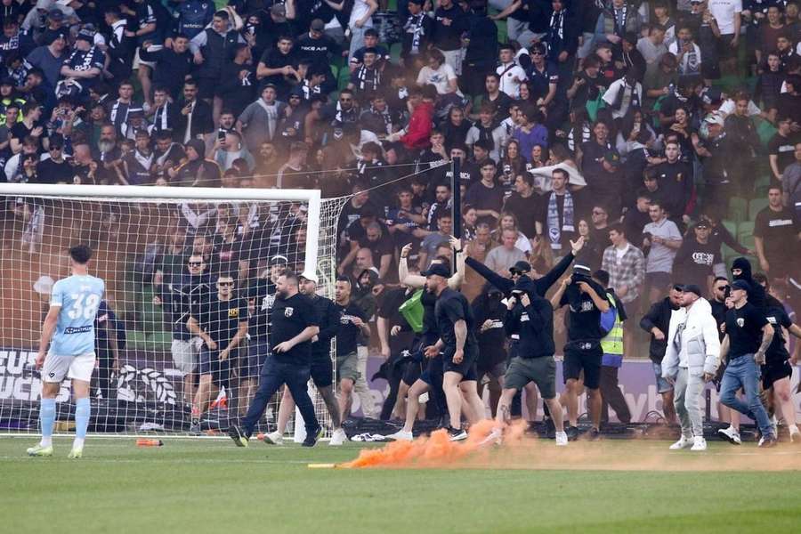 Melbourne City keeper hit by bin during chaotic pitch invasion in A-League