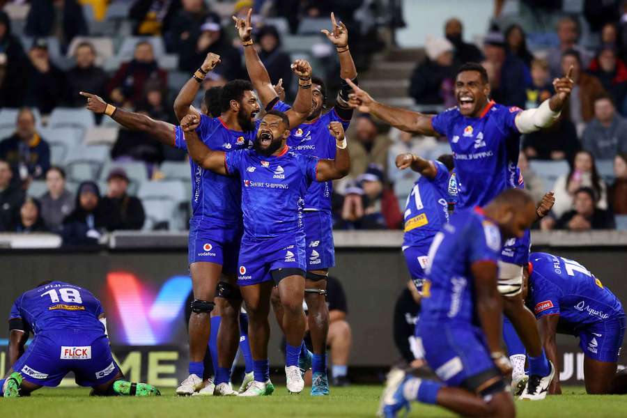Fijian Drua players celebrate their maiden victory on Australian soil.