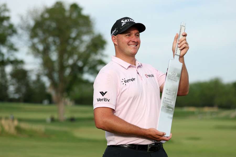 Straka poses with the trophy after his win