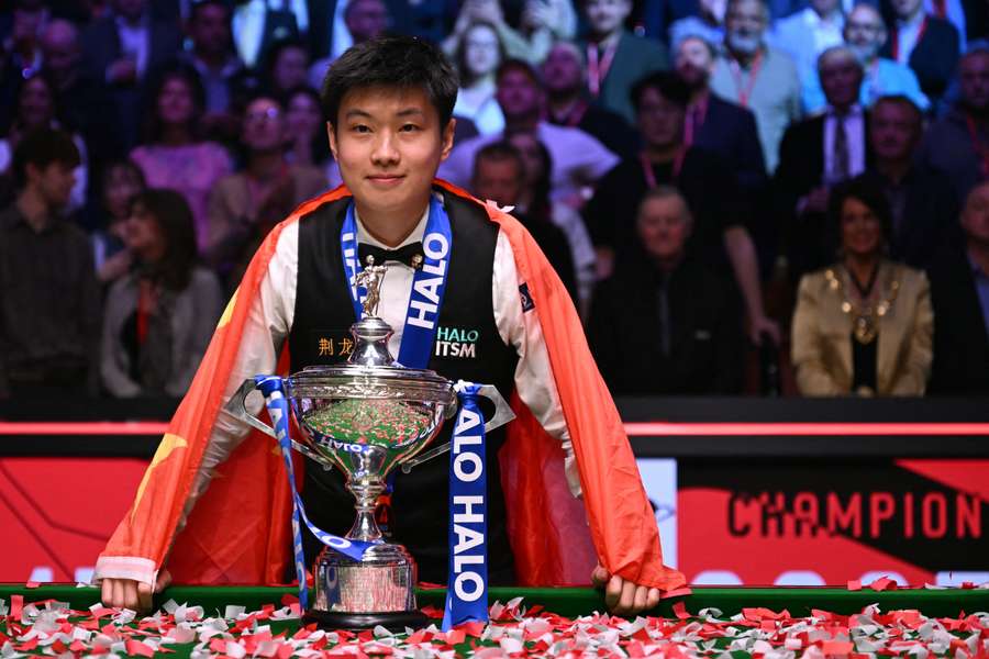 China's Zhao Xintong poses with the trophy after winning the World Snooker Championship