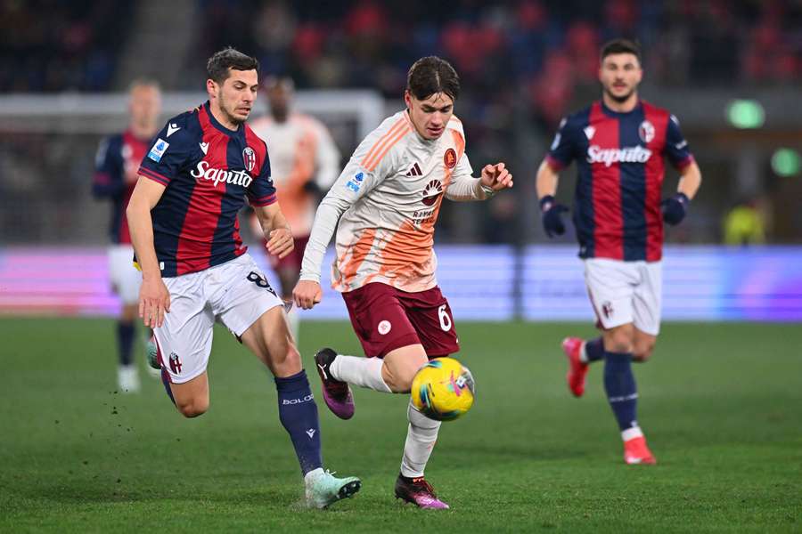Bologna's Remo Freuler (left) battles for the ball with Niccolo Pisilli of Roma