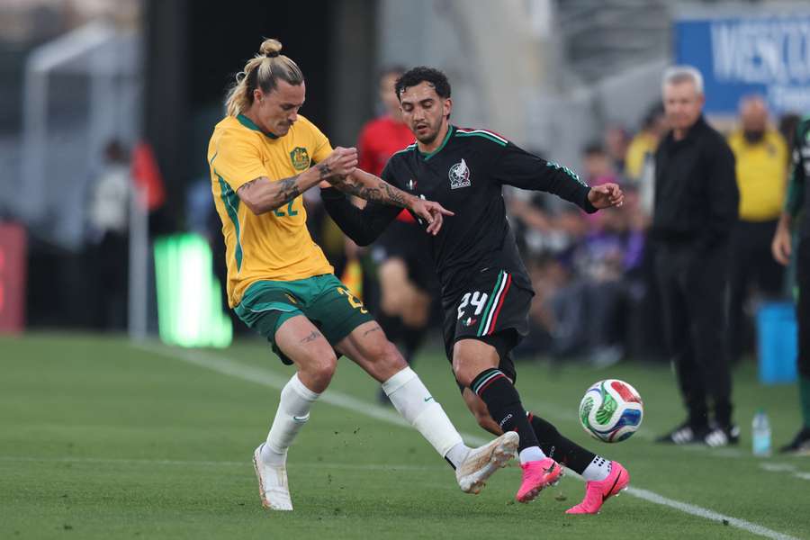 Jackson Irvine competes with Luis Chávez during Australia's recent 1-0 loss to Mexico.