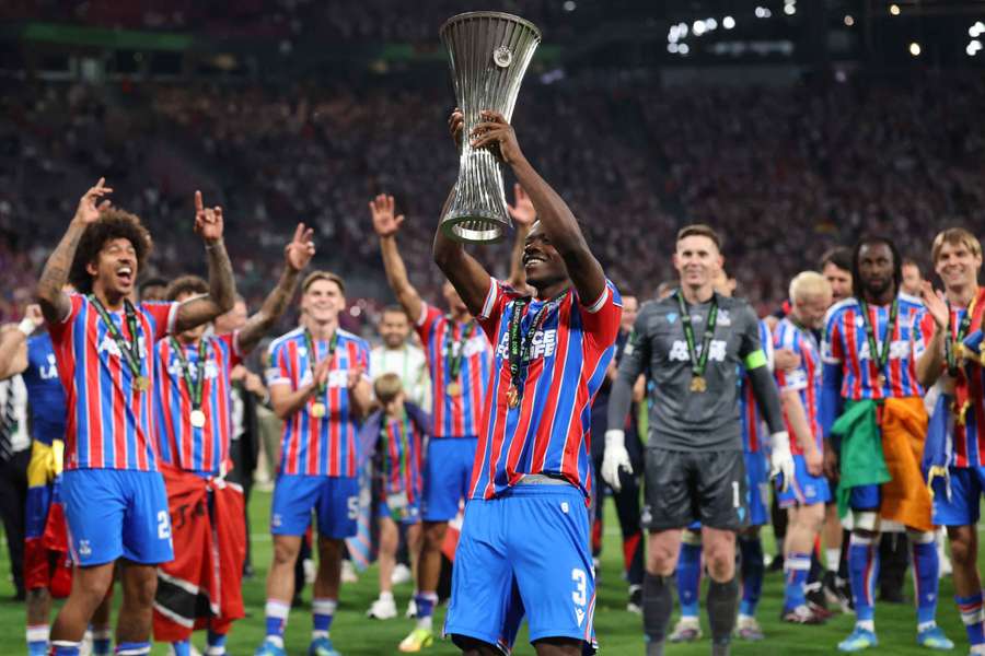 Tyrick Mitchell lifts the UEFA Conference League trophy.