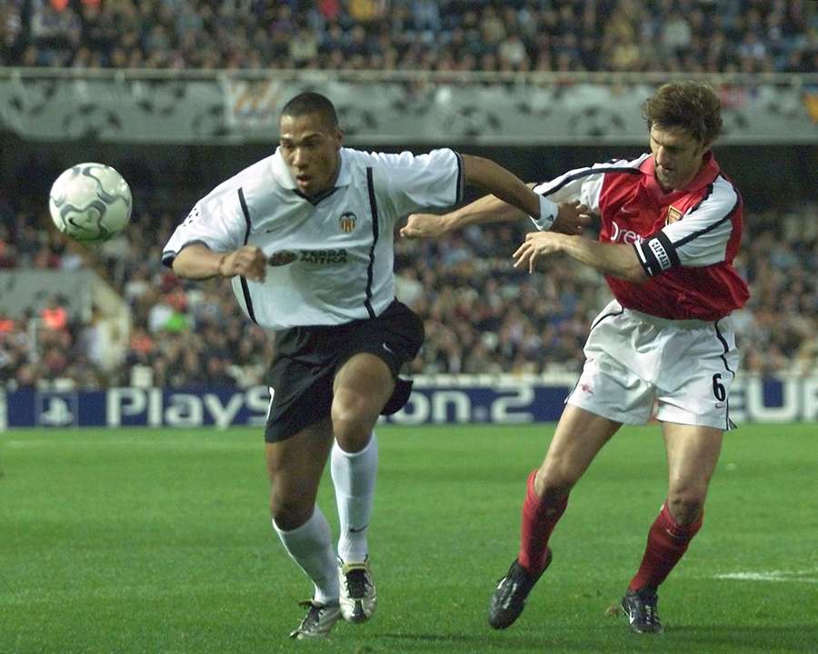 Valencia forward John Carew battles past Arsenal captain Tony Adams Valencia forward John Carew battles past Arsenal captain Tony Adams