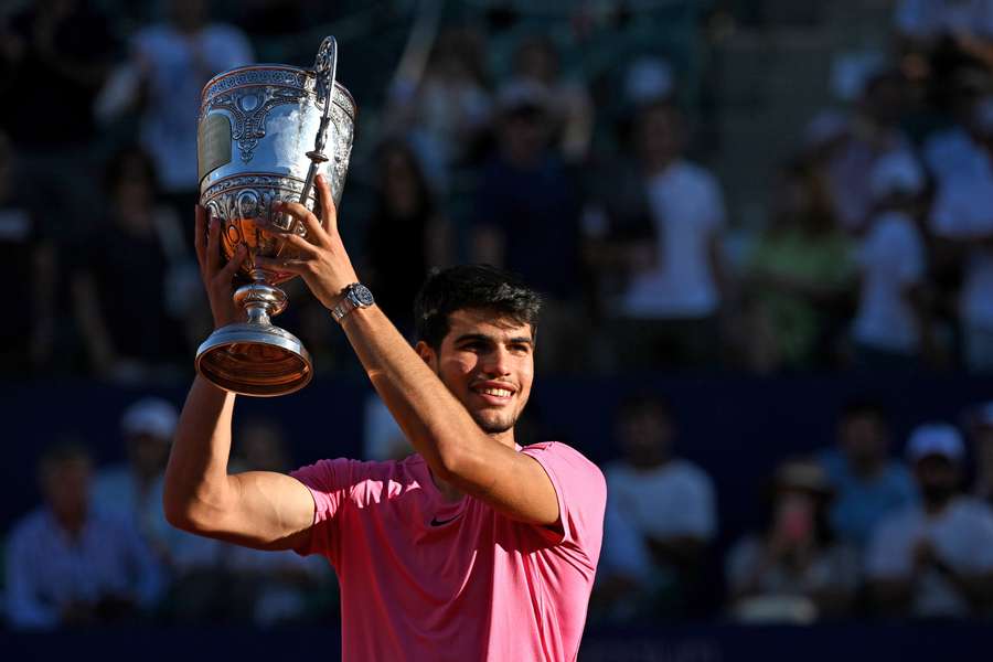 Carlos Alcaraz celebrates with the trophy
