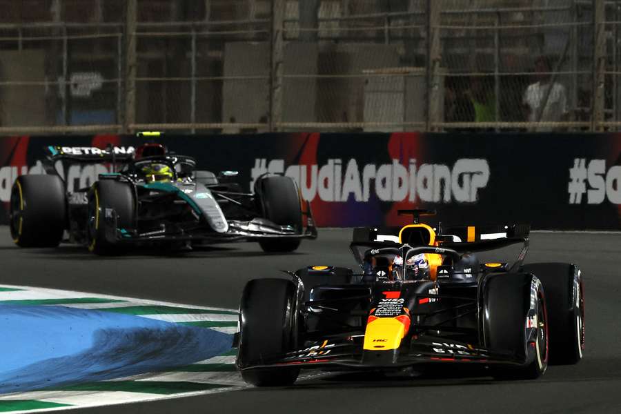 Red Bull Racing's Dutch driver Max Verstappen (R) and Mercedes' British driver Lewis Hamilton compete during the Saudi Arabian Formula 1 Grand Prix