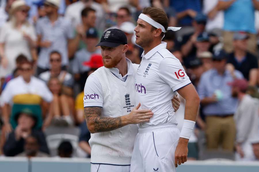 England's Stuart Broad (R) is congratulated by Ben Stokes (L) after taking the wicket of Australia's Usman Khawaja