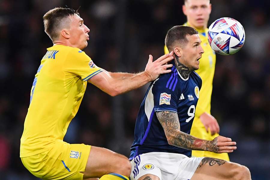 Scotland striker Lyndon Dykes goes for a header with Ukraine midfielder Serhiy Sydorchuk during the UEFA Nations League B match at Hampden Park